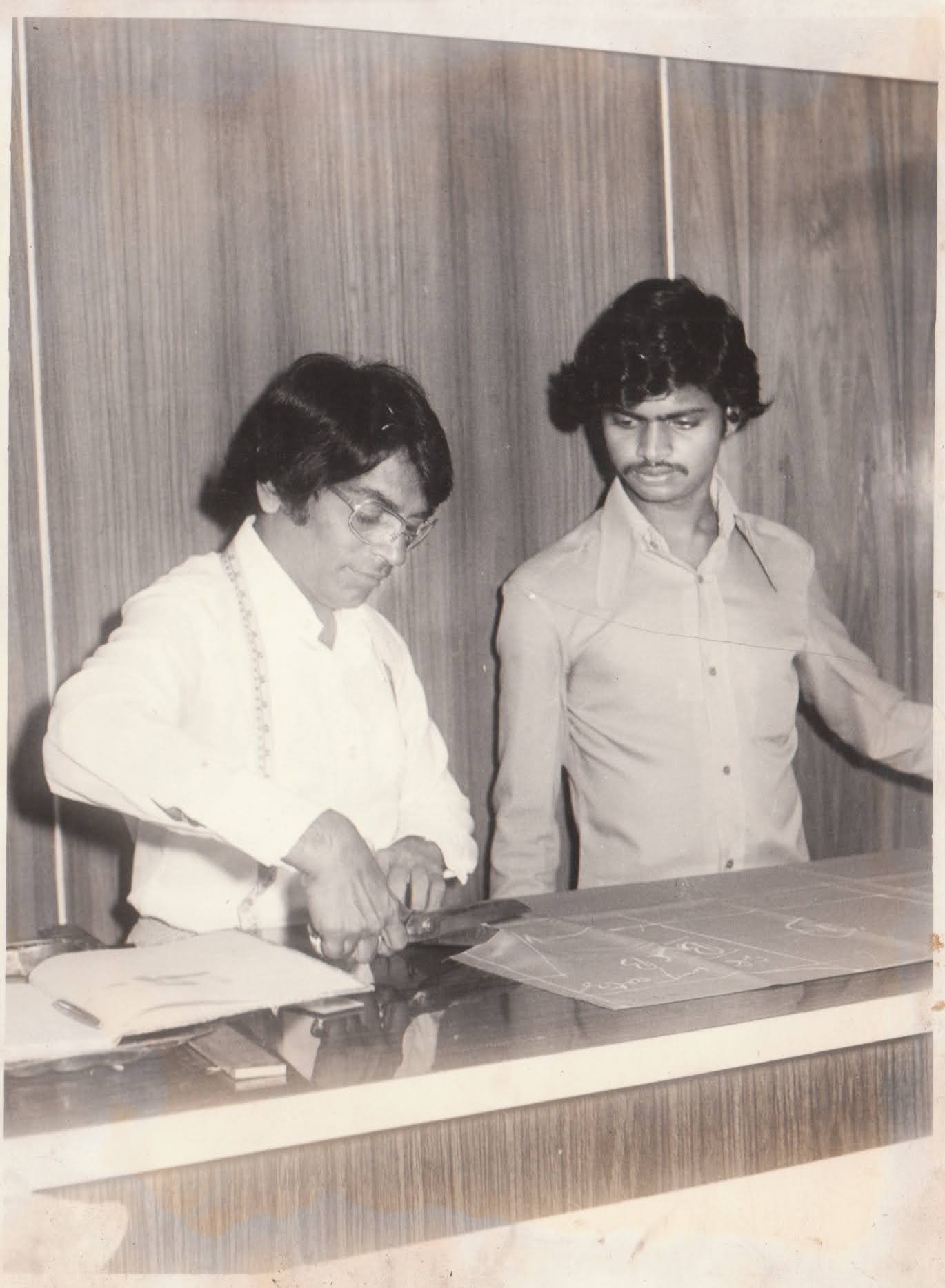 1976 photo of a tailor cutting fabric at Seam Ster